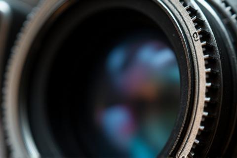 Macro shot of a vintage camera's lens and aperture blades.